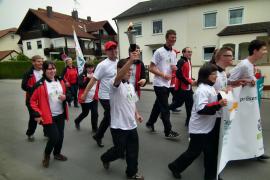 Die Olchinger Sportler bei ihrem Lauf mit der olympischen Flamme durch Olching.